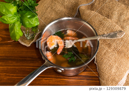 Seafood red shrimps in a pan, on a wooden table Seafood red shrimps in a pan, on a wooden table 129309879