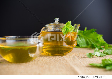 Aromatic herbal tea from mint and currant on a black background Aromatic herbal tea from mint and currant on a black background 129309906