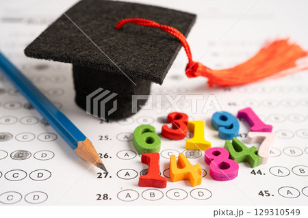 Math Number colorful with graduation hat and pencil on answer sheet paper. Math Number colorful with graduation hat and pencil on answer sheet paper. 129310549