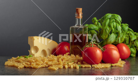 Ingredients for preparing traditional Italian pasta with cheese. 129310707