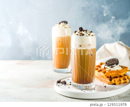 coffee moment, two iced lattes in tall ribbed glass coffee moment, two iced lattes in tall ribbed glass 129311976