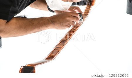 Man Inspecting Film Strip 129312092