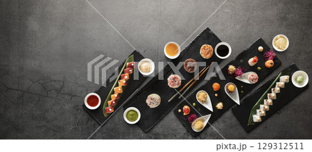 Mix of japanese sushi rolls and sauces 129312511