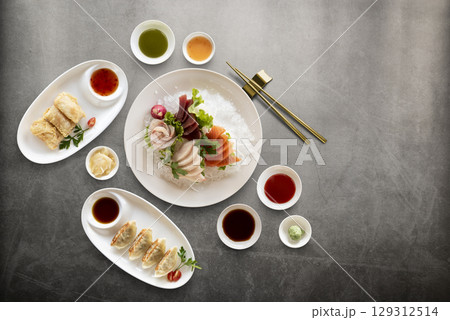 Mix of fresh sashimi raw fish and sauces Mix of fresh sashimi raw fish and sauces 129312514
