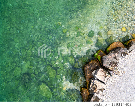 Aerial drone view of Lago di Garda (lake Garda) coastline, Italy. The beach and fresh blue water. 129314402