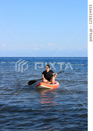 Solo Kayaker on Calm Waters 129314455