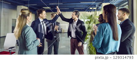 Business People Giving High Five And Celebrating Success In A Team Meeting Business People Giving High Five And Celebrating Success In A Team Meeting 129314793
