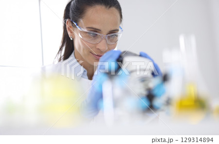 Innovative scientist engaged in groundbreaking research in bright laboratory during afternoon hours 129314894