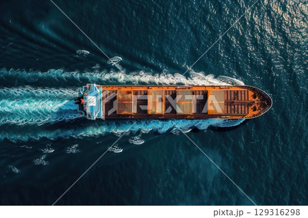 Large cargo ship sailing in open blue sea, top aerial view 129316298