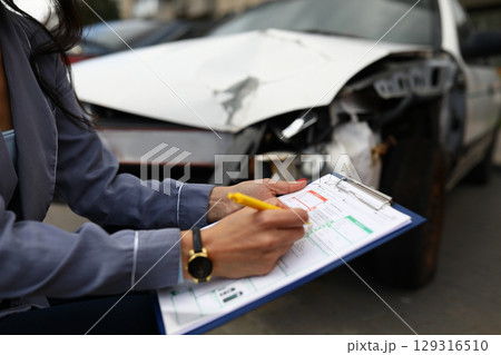 Documenting the aftermath of a car accident with attention to detail and thoroughness in a busy urban setting Documenting the aftermath of a car accident with attention to detail and thoroughness in a busy urban setting 129316510