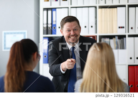 Business presentation motivating team members with enthusiasm in modern office setting during daytime 129316521