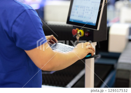 operator working with industrial control console 129317532
