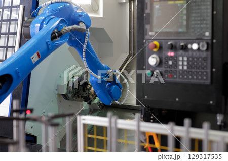 robot loading parts into CNC lathe machine robot loading parts into CNC lathe machine 129317535