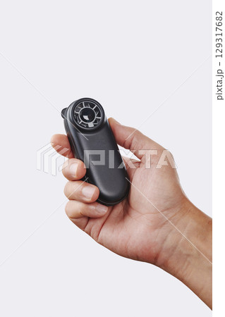 a man cools himself with a black handheld fan 129317682