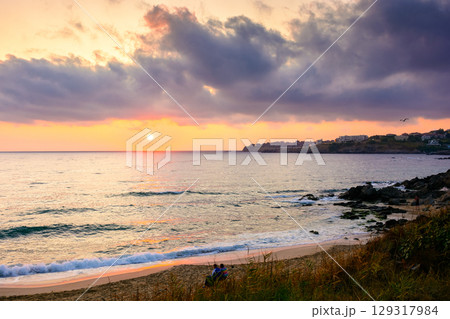 sea beach landscape on autumn sunrise. calm wave on sand shore. dramatic clouds above horizon. velvet season vacation in bulgaria sea beach landscape on autumn sunrise. calm wave on sand shore. dramatic clouds above horizon. velvet season vacation in bulgaria 129317984