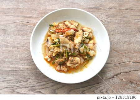 stir-fried spicy squid with salty egg and sauce on dish stir-fried spicy squid with salty egg and sauce on dish 129318190