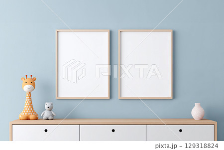 Modern blank frame set of 2 for wall art mockup in neutral blue nursery with wooden accents and playful decor featuring a giraffe and bear 129318824