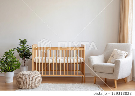 Nursery room is adorned with soft textures, neutral tones, and a lively plant, perfect for a newborn's space. Empty beige wall with copy space. 129318828