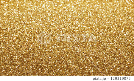 Shimmering gold glitter texture backdrop perfect for celebrations, events, or creative projects showcasing sparkle and elegance in a vibrant and eye-catching manner 129319073