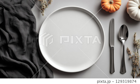 Mockup of plain white plate on Halloween theme background with copy space for text, Bright white color tone. 129319874
