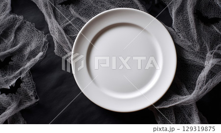 Mockup of plain white plate on Halloween theme background with copy space for text, Black and white color tone. 129319875