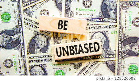 Be unbiased symbol. Concept words Be unbiased on wooden block. Beautiful background from dollar bills. Dollar bills. Business psychology be unbiased concept. Copy space. 129320008