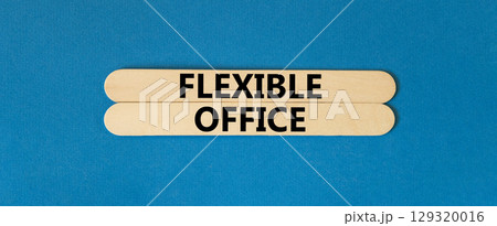 Flexible office symbol. Concept words Flexible office on beautiful wooden stick. Beautiful blue paper background. Business Flexible office concept. Copy space. 129320016