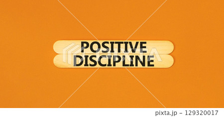 Positive discipline symbol. Concept words Positive discipline on beautiful wooden stick. Beautiful orange table orange background. Business psychology positive discipline concept. Copy space. Positive discipline symbol. Concept words Positive discipline on beautiful wooden stick. Beautiful orange table orange background. Business psychology positive discipline concept. Copy space. 129320017