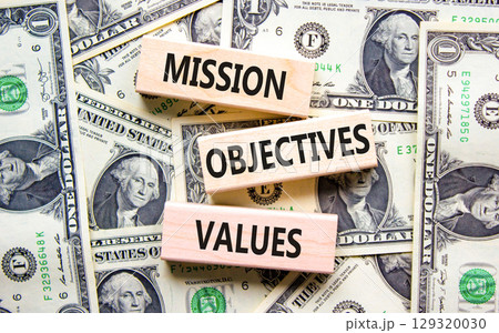 Mission objectives values symbol. Concept words Mission Objectives Values on beautiful blocks. Dollar bills. Beautiful dollar bills background. Business mission objectives values concept. Copy space. Mission objectives values symbol. Concept words Mission Objectives Values on beautiful blocks. Dollar bills. Beautiful dollar bills background. Business mission objectives values concept. Copy space. 129320030