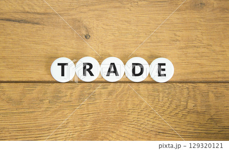 Trade symbol. Concept word Trade on beautiful white pills circles. Beautiful wooden table wooden background. Business lifestyle trade concept. Copy space. 129320121