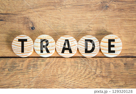 Trade symbol. Concept word Trade on beautiful wooden circles. Beautiful wooden table wooden background. Business lifestyle trade concept. Copy space. Trade symbol. Concept word Trade on beautiful wooden circles. Beautiful wooden table wooden background. Business lifestyle trade concept. Copy space. 129320128