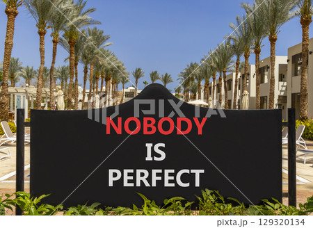 Nobody is perfect symbol. Concept words Nobody is perfect on beautiful black road sign. Beautiful palm tree hotel background. Business motivational lifestyle and nobody is perfect concept. Copy space. 129320134