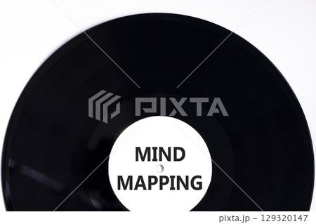 Mind mapping symbol. Concept words Mind mapping on beautiful black vinyl disk on a beautiful white table white background. Business, support, motivation, psychological mind mapping concept. Copy space Mind mapping symbol. Concept words Mind mapping on beautiful black vinyl disk on a beautiful white table white background. Business, support, motivation, psychological mind mapping concept. Copy space 129320147