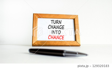 Turn change into chance symbol. Concept words phrase Turn change into chance on beautiful wooden picture frame. Beautiful white background. Business Turn change into chance concept. Copy space. 129320183