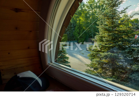 Window view of a forest with a road in the background Window view of a forest with a road in the background 129320714