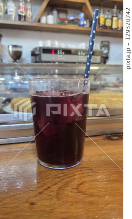 Refreshing tinto de verano beverage in a cozy cafe setting. Traditional spanish summer cocktail with wine and ice 129320742