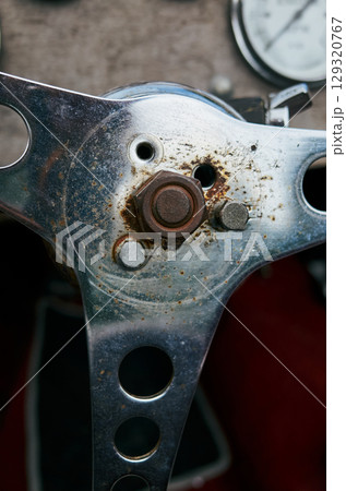Close up of a car's steering wheel with a bolt missing 129320767