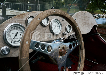 Vintage car with a wooden steering wheel and gauges Vintage car with a wooden steering wheel and gauges 129320777