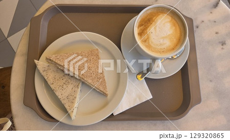 Cozy morning breakfast with cappuccino and sandwiches. Top view. Flat lay Cozy morning breakfast with cappuccino and sandwiches. Top view. Flat lay 129320865