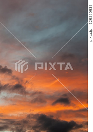 The sky is filled with clouds and the sun is setting. Vertical background, wallpapers. The sky is filled with clouds and the sun is setting. Vertical background, wallpapers. 129320935