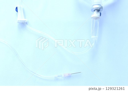 needle for saline solution and rubber tube arranging on white background 129321261
