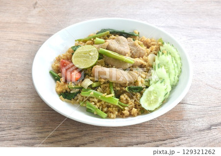 fried rice solf fermenting pork in black sweet soy sauce with slice cucumber couple lemon on plate fried rice solf fermenting pork in black sweet soy sauce with slice cucumber couple lemon on plate 129321262