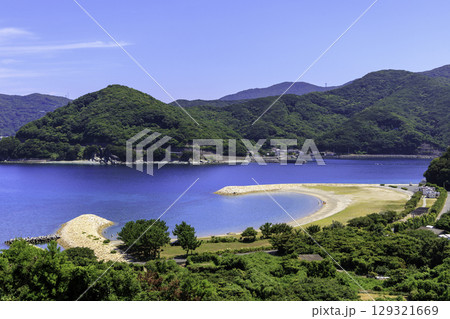 澄んだ青い海と緑の山が広がるムーンビーチ井野浦の絶景風景 澄んだ青い海と緑の山が広がるムーンビーチ井野浦の絶景風景 129321669