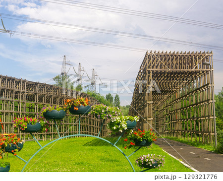 wooden roof over the bike path in the park, protects against possible falling wire of power lines 129321776