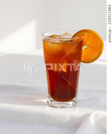 Refreshing iced tea with an orange slice, perfect for a sunny day refreshment, beverage drink 129321963