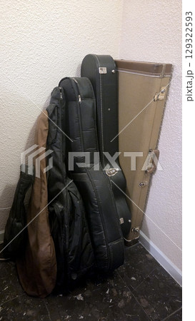 Collection of guitar cases in room corner 129322593