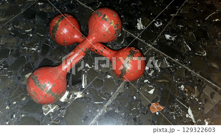 Vintage red dumbbells on marble floor for fitness and exercise concept. Horizontal banner. Copy space 129322603