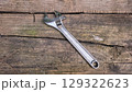 Adjustable spanner on rustic wooden surface for tool and diy projects. Horizontal banner. Copy space. Shifting spanner or adjustable wrench. Swedish key 129322623