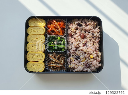 Korean Bento Box with Rolled Omelet, Stir-Fried Peppers, and Seasoned Vegetables 129322761