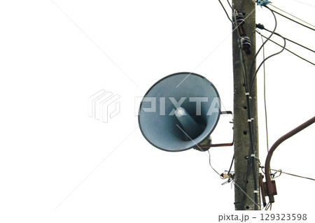 Vintage loudspeaker on pole with messy wires 129323598